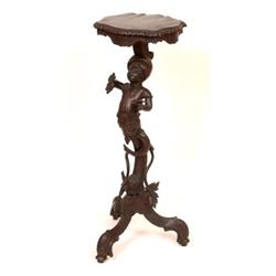 A Continental Carved Wood Jardinière Stand, on a figural column and tripod base,   See illustrati...