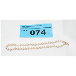 Estate tied pearls, clasp stamped 10k gold