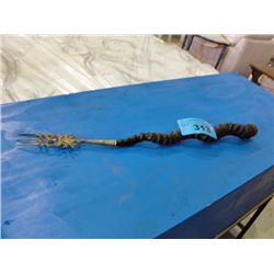 Vintage gazelle horn with brass accents campfire