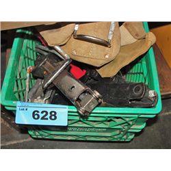 Green milk crate of assorted tools and hardware