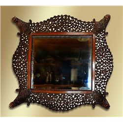 Phenomenal hand carved mahogany hanging mirror with the original beveled mirror
