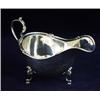 Image 1 : A SILVER SAUCE BOAT: with tube lined and decorated rim with scroll  handle, raised three scroll a...