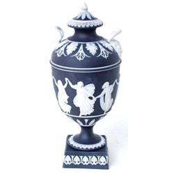 A WEDGWOOD BLACK JASPERWARE TWO HANDLED COVERED URN: the body  decorated dancing classical female...