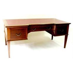 AN EDWARDIAN MAHOGANY INLAID AND SATIN BANDED BREAKFRONT WRITING  DESK: the top inset a red skive...