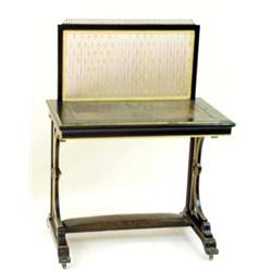 AN EDWARDIAN EBONISED WRITING TABLE: the top with moulded edge and  inset a tooled green skiver,...
