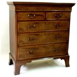 AN EDWARDIAN MAHOGANY CHEST: of two short and three long graduated  drawers, the top with moulded...