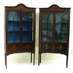 A PAIR OF EDWARDIAN MAHOGANY DISPLAY CABINETS: with arched moulded  pediment over a simulated inl...