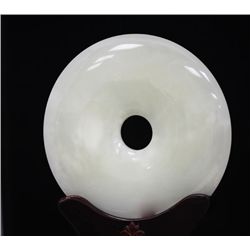 ROUND JADE STATUE WITH ANTIQUE WOOD BASE.