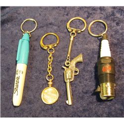329. Malaysia 10 Sen Coin Key ring; Sharpie Key ring; Sparkplug Key ring; & a Six-shooter Key ring.