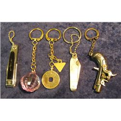 333. (5) Different Key rings: Pirate Pistol; Ancient Chinese Coin, Mother-of-pearl U.S.A. Knife; Fin