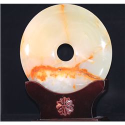 ROUND JADE STATUE WITH ANTIQUE WOOD BASE.
