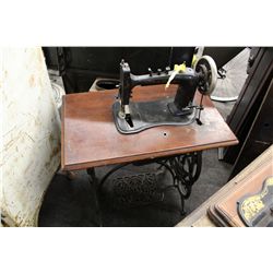 DOMESTIC TREADLE SEWING MACHINE FITTED INTO A TABLE WITH SWING-OUT DRAWERS WITH CARVED IRON LEGS