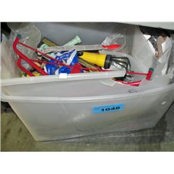 Clear plastic storage bin of tools hardware and