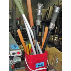 Red pail filled with assorted garden tools