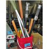 Image 1 : Red pail filled with assorted garden tools