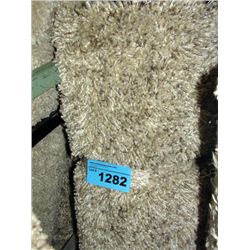 Small off white and multi colored beige shag area