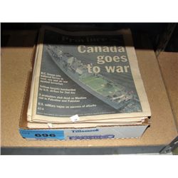 Box full of vintage newspapers with historic head