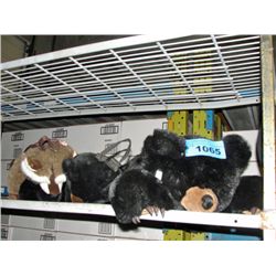 Stuffed black bear doll and a racoon and bear