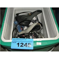Green cooler filled with bike parts and accessoris
