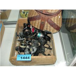 Wood crate filled with assorted fishing reels and