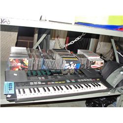 Shelf lot of music CDs and a yamaha keyboard