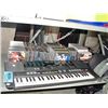 Image 1 : Shelf lot of music CDs and a yamaha keyboard