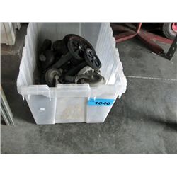Clear plastic storage bin of assorted casters