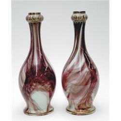 A pair of opaque glass bottle vases streaked in brown and cream with enamelled necks, 13.5ins £10...