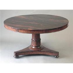 A Regency rosewood breakfast table with circular tilt top, on lotus carved column with triangular...