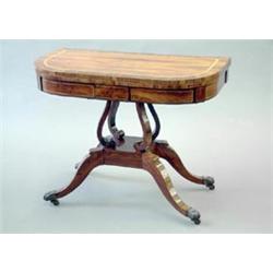 A Regency satinwood banded coromandelwood card table with folding D shaped top, scrolled stem and...