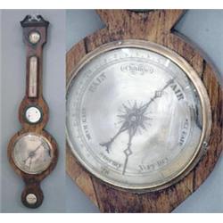 An early Victorian rosewood wheel barometer with swan neck pediment and silvered dials, 3ft.1in....