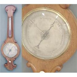 A Victorian oak wheel barometer carved with c-scrolls, fitted with silvered dials, 3ft. £200-300...