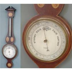 An Edwardian inlaid mahogany wheel barometer by A. Steward, Leicester, broken arch pediment above...