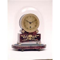 A Regency ormolu mounted red tortoiseshell mantel timepiece with engine turned gilt dial, drum mo...