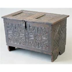 A 17th century oak coffer with rising panelled top and later floral carving, on stile feet, 2ft.4...