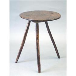 An 18th century elm cricket table with circular top, 1ft.8ins. £500-700...
