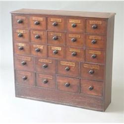 An early 19th century mahogany apothecary chest with an arrangement of 23 titled drawers with tur...