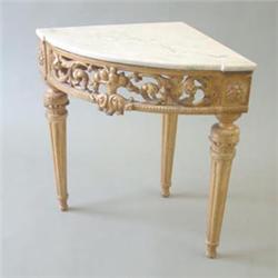 A George II style gilt gesso corner console table, the carrera marble top over pierced scrolling...