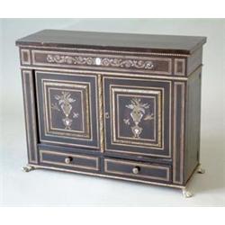 A 19th century brass and ivory inlaid ebonised table cabinet, with 2 doors decorated with floral...