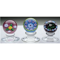 THREE KAZIUN PEDESTAL PAPERWEIGHTS.