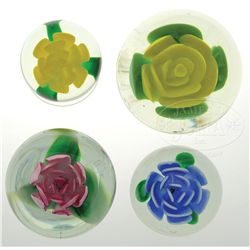 FOUR ROBERT HAMON CRIMP ROSE PAPERWEIGHTS.