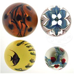 FOUR SURFACE DECORATED PAPERWEIGHTS.