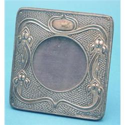 An Edwardian Art Nouveau silver mounted photograph frame decorated with irises, 4ins. £100-150...