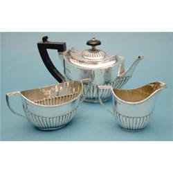 A late Victorian demi fluted silver bachelor's teapot, together with a similar sugar bowl and cre...