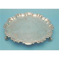 A William IV silver salver with piecrust scroll border, floral scroll engraving and scroll feet,...