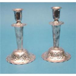 A pair of Swedish white metal candlesticks with floral decoration, 6ins. £80-120...