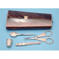 A 19th century French rosewood etui fitted with white metal needlecase, stiletto, pair of scissor...