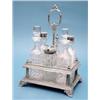 Image 1 : An Elkington & Co. plated cruet stand fitted with a set of 6 cut glass condiments £100-150...