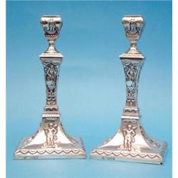 A pair of Victorian silver candlesticks decorated with figures of Britannia and Hercules, 9.25ins...