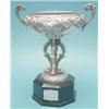 Image 1 : A Portuguese white metal trophy cup with flying scroll handles, jockey on horseback panel and ebo...